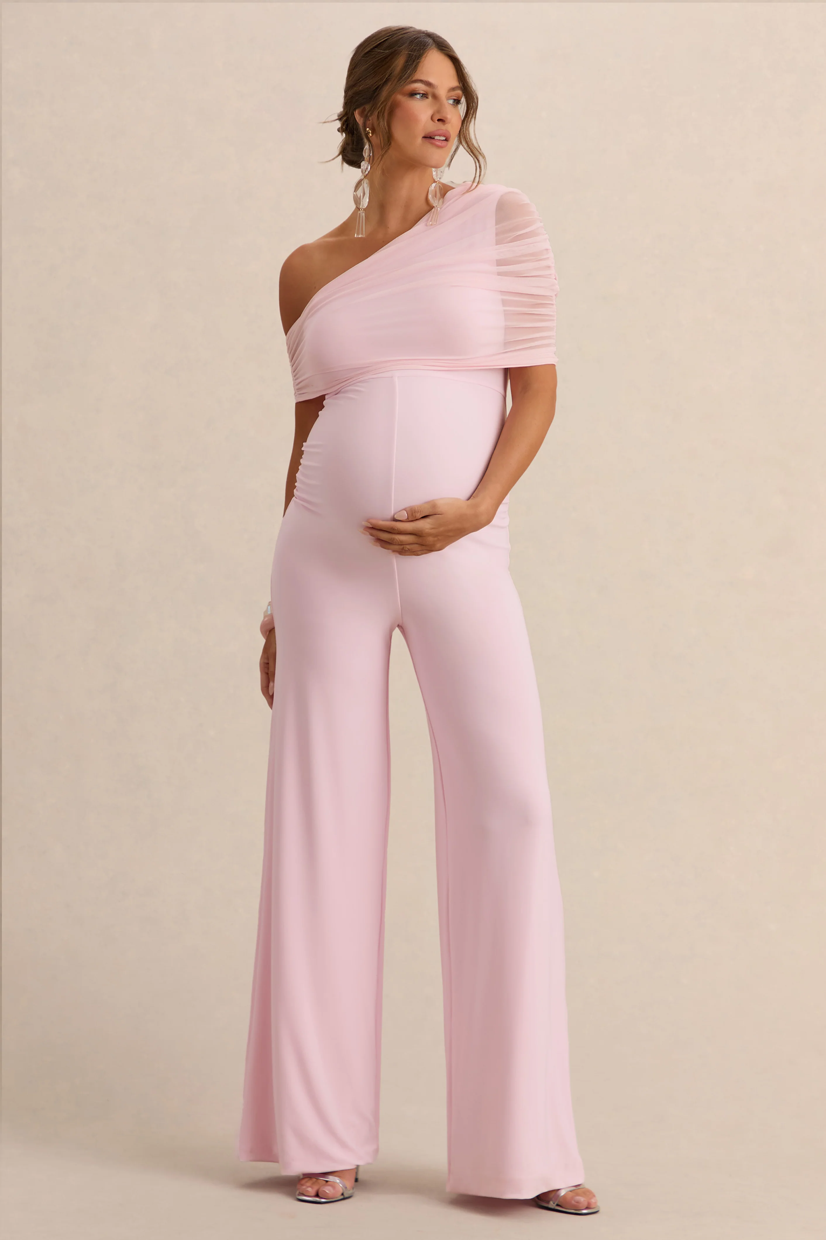 Mariska | Licht Roze Zwangerschaps Jumpsuit Met Asymmetrische Hals En Ceintuurdetail